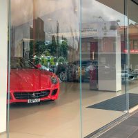 Ferrari-Showroom curved glass close up shot